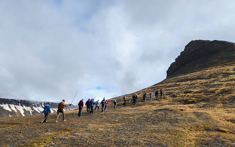 Hikers hiking up a mountain in the Arctic